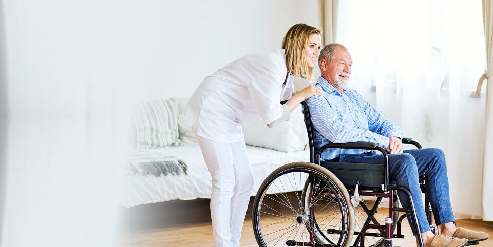 man on wheelchair and his caregiver