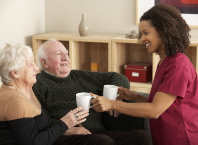 caregiver serving elderly a tea